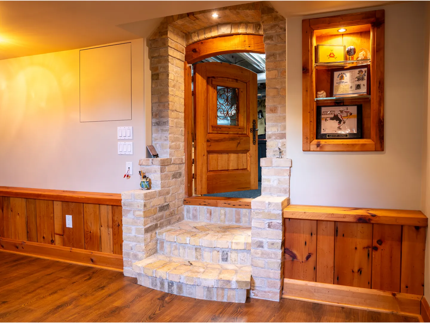 Curved brick steps leading to a custom timber door