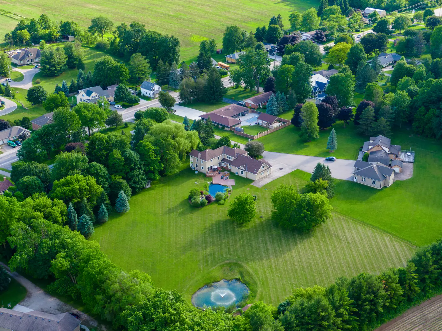 Aerial view across the residence, lawn and water features