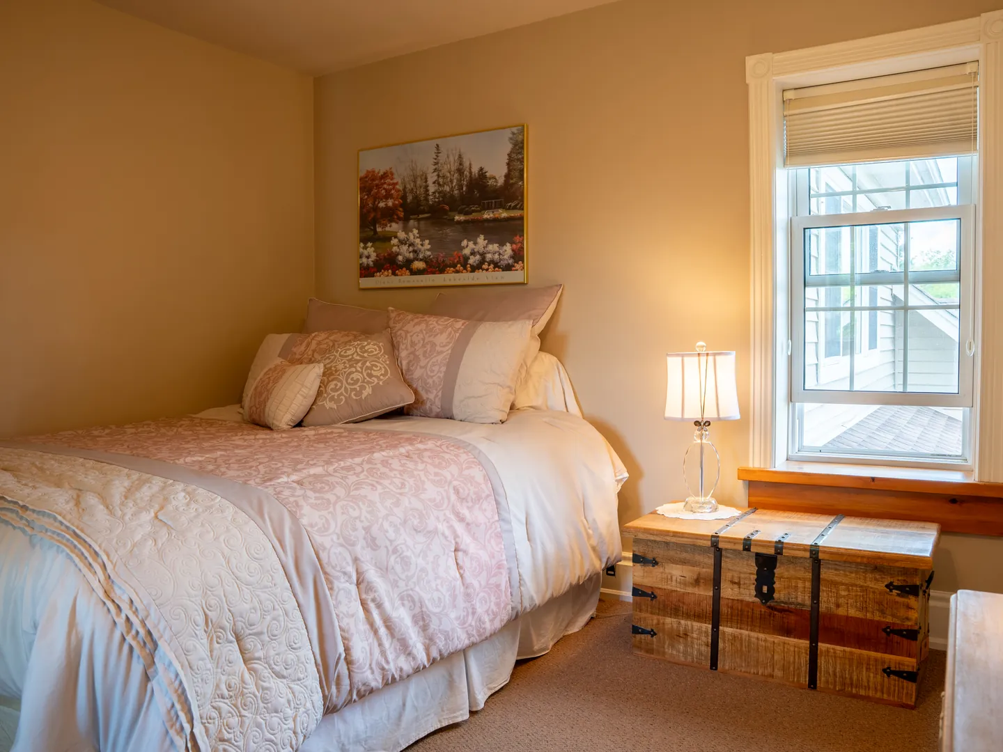 Softly furnished bedroom with timber window trim