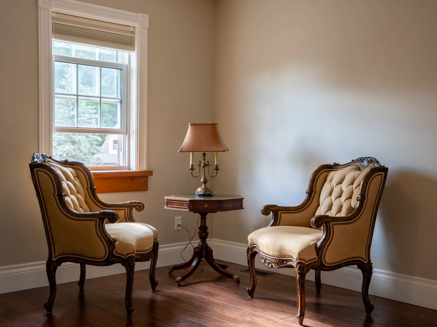 Quiet sitting room with two antique-style chairs