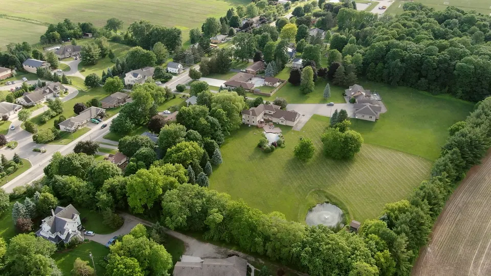 Elevated aerial view of the house and natural pool