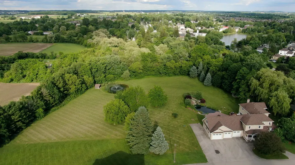 Aerial view sweeping across the lawn and tree line